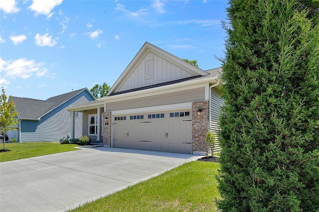 view of front of property with board and batten siding, concrete driveway, an attached garage, and a front lawn
