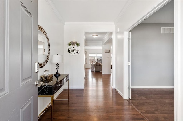 foyer featuring wood finished floors, baseboards, and ornamental molding