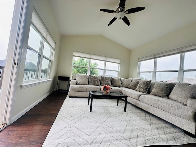 living area with dark wood-style flooring, lofted ceiling, ceiling fan, and baseboards