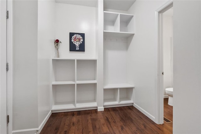 mudroom with wood finished floors and baseboards