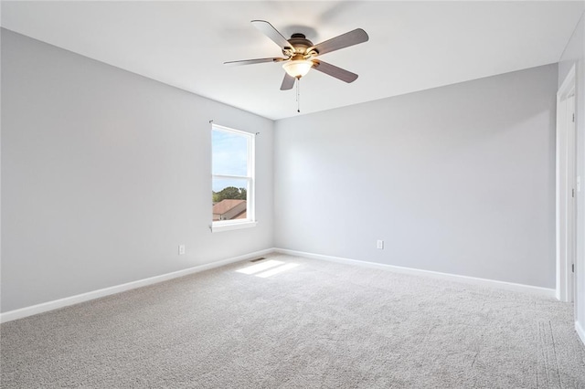 empty room with ceiling fan, baseboards, and carpet