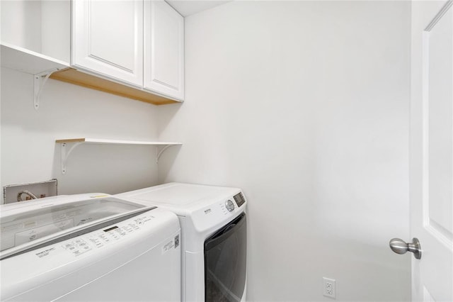 laundry room featuring washer and dryer and cabinet space