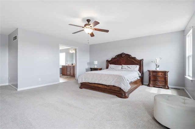 carpeted bedroom with baseboards, ceiling fan, and ensuite bathroom