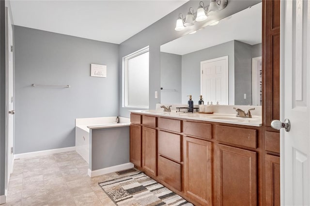 bathroom with double vanity and baseboards