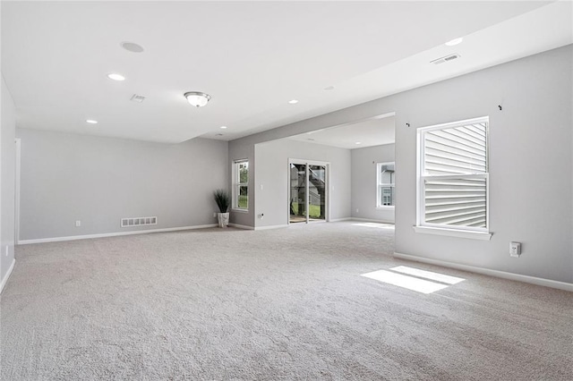 spare room with carpet, recessed lighting, and baseboards