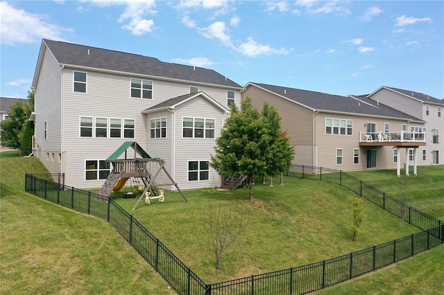 back of property featuring a playground