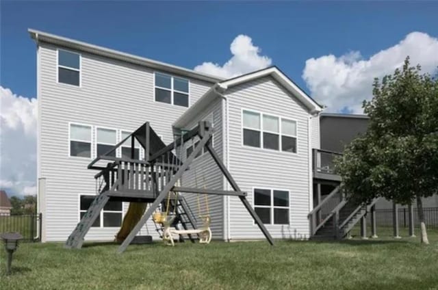 back of property featuring stairs and a deck