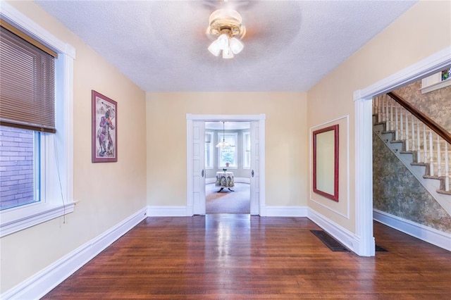 4526 Gibson Ave, Saint Louis, MO 63110 - foyer with wood finished floors, stairs, baseboards, a textured ceiling, and ceiling fan