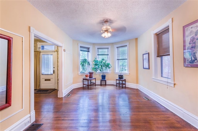 4526 Gibson Ave, Saint Louis, MO 63110 - living area with a textured ceiling, dark wood finished floors, ceiling fan, and baseboards