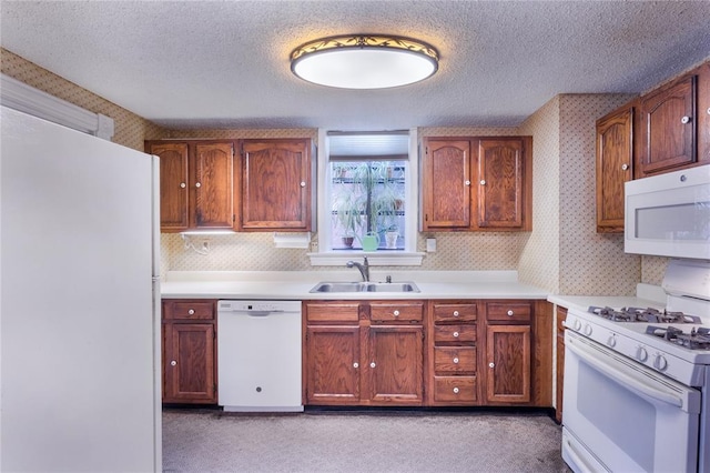 4526 Gibson Ave, Saint Louis, MO 63110 - kitchen featuring white appliances, wallpapered walls, a sink, a textured ceiling, and light countertops