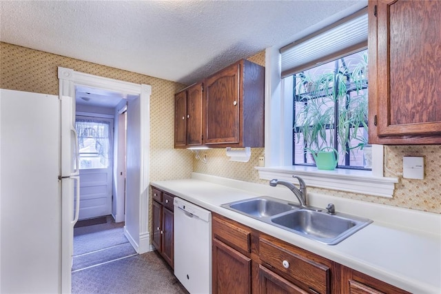 4526 Gibson Ave, Saint Louis, MO 63110 - kitchen with white appliances, a sink, wallpapered walls, light countertops, and a textured ceiling