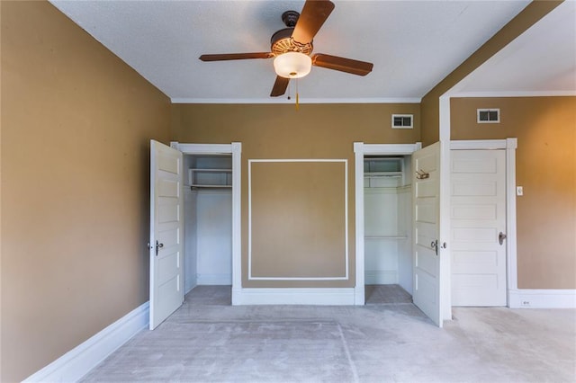 4526 Gibson Ave, Saint Louis, MO 63110 - unfurnished bedroom with multiple closets, baseboards, ornamental molding, carpet, and a ceiling fan