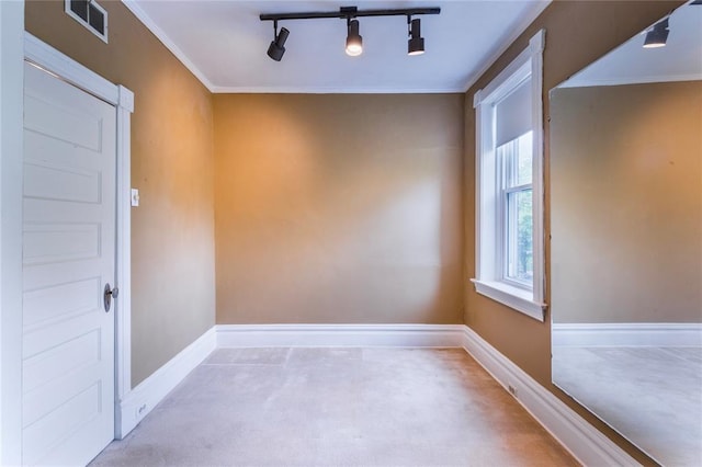 4526 Gibson Ave, Saint Louis, MO 63110 - spare room with carpet, baseboards, crown molding, and track lighting
