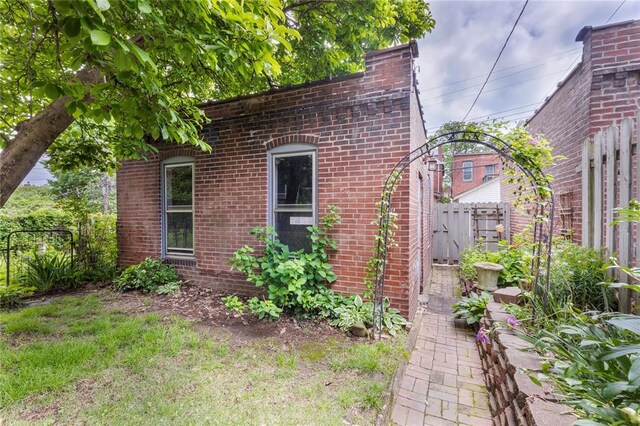 4526 Gibson Ave, Saint Louis, MO 63110 - view of property exterior with fence and brick siding