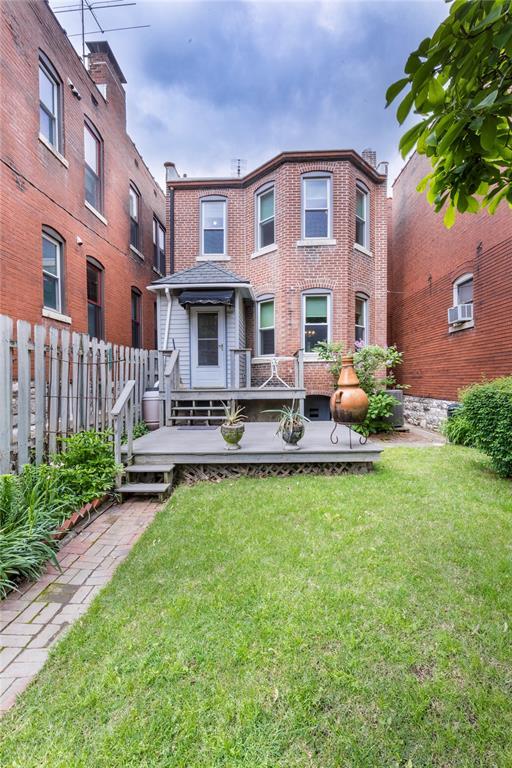 4526 Gibson Ave, Saint Louis, MO 63110 - back of property featuring a deck and brick siding