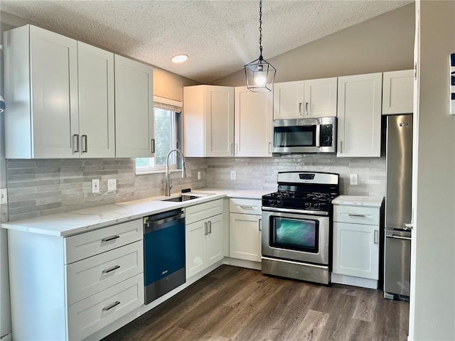3060 Laurel Village Cir, Saint Peters, MO 63376 - kitchen with appliances with stainless steel finishes, a sink, a textured ceiling, vaulted ceiling, and white cabinets