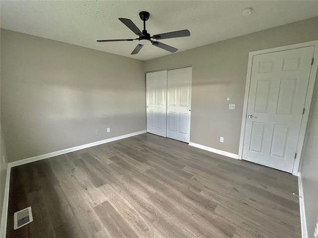 3060 Laurel Village Cir, Saint Peters, MO 63376 - unfurnished bedroom with wood finished floors, a closet, baseboards, a textured ceiling, and a ceiling fan