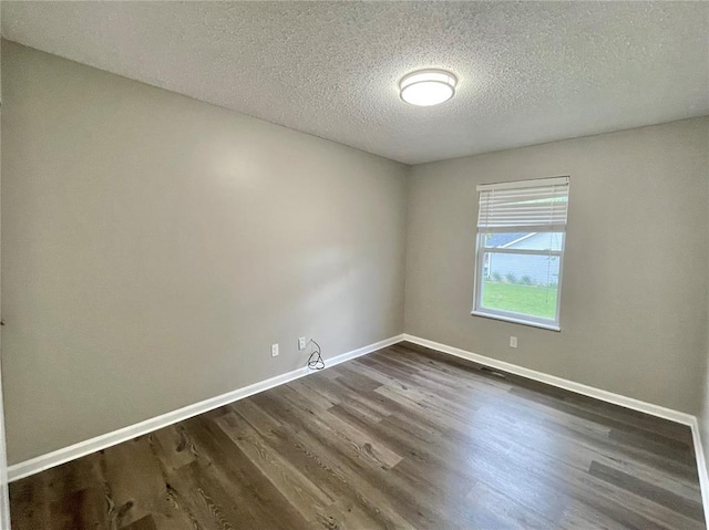 3060 Laurel Village Cir, Saint Peters, MO 63376 - spare room with dark wood finished floors, a textured ceiling, and baseboards