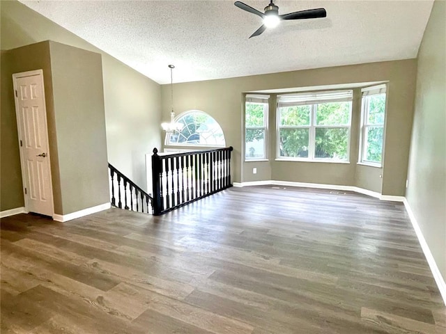 3060 Laurel Village Cir, Saint Peters, MO 63376 - spare room featuring a textured ceiling, ceiling fan, baseboards, and wood finished floors