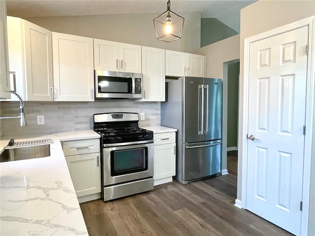 3060 Laurel Village Cir, Saint Peters, MO 63376 - kitchen featuring appliances with stainless steel finishes, a sink, vaulted ceiling, decorative backsplash, and white cabinetry