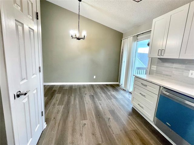 3060 Laurel Village Cir, Saint Peters, MO 63376 - kitchen featuring dishwashing machine, vaulted ceiling, dark wood-style flooring, a textured ceiling, and a chandelier
