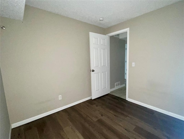 3060 Laurel Village Cir, Saint Peters, MO 63376 - spare room featuring dark wood-style flooring, baseboards, and a textured ceiling