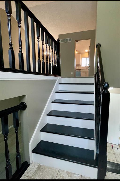 3060 Laurel Village Cir, Saint Peters, MO 63376 - staircase with tile patterned floors