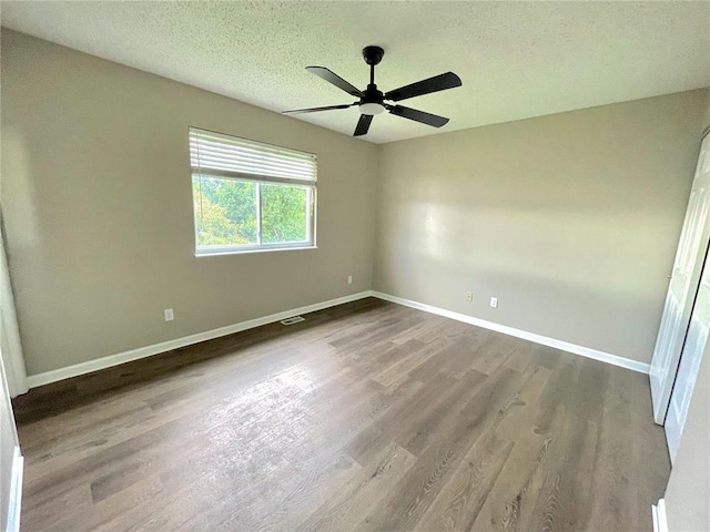 3060 Laurel Village Cir, Saint Peters, MO 63376 - unfurnished room with ceiling fan, wood finished floors, baseboards, and a textured ceiling