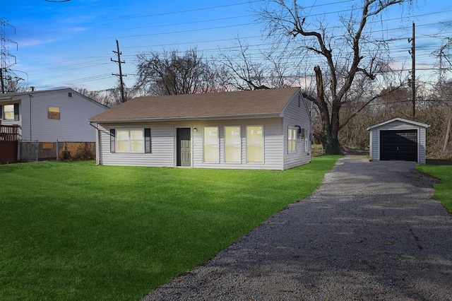11893 Bridgevale Ave, Saint Louis, MO 63138 - view of front of house with an outbuilding, asphalt driveway, a garage, a front lawn, and roof with shingles