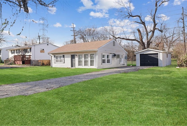 11893 Bridgevale Ave, Saint Louis, MO 63138 - view of front of home with an outbuilding, a garage, and a front yard