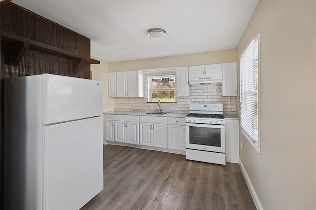 11893 Bridgevale Ave, Saint Louis, MO 63138 - kitchen featuring white appliances, under cabinet range hood, a sink, tasteful backsplash, and light countertops