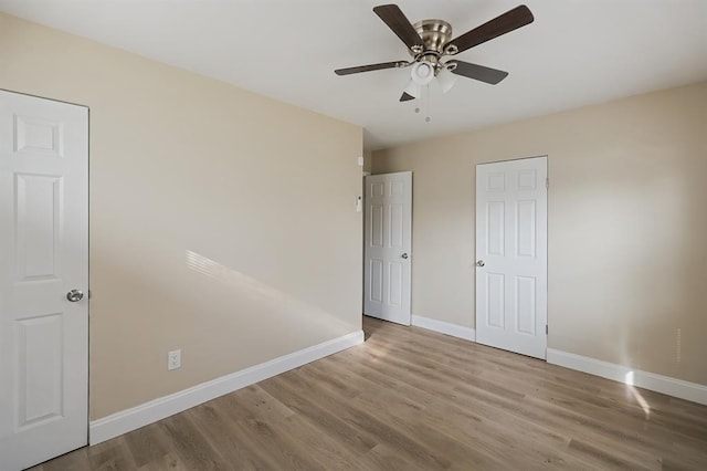 11893 Bridgevale Ave, Saint Louis, MO 63138 - unfurnished bedroom featuring baseboards, wood finished floors, and ceiling fan