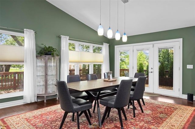 dining room with high vaulted ceiling and wood finished floors