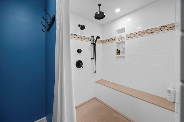 full bathroom with tiled shower and pet washing area