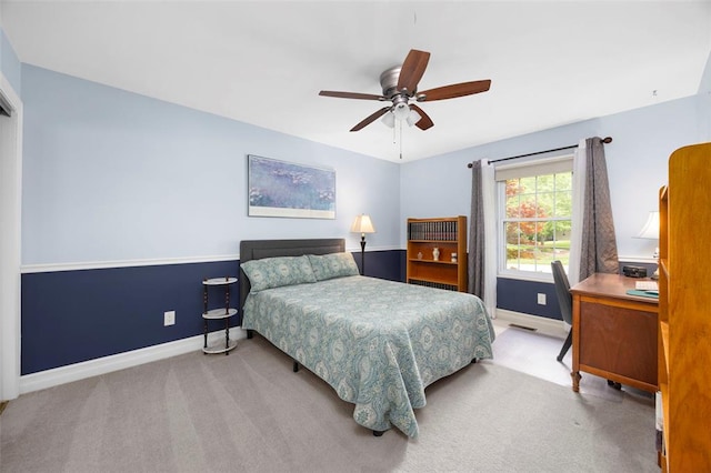 carpeted bedroom featuring baseboards, a desk, and ceiling fan