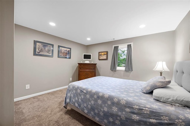 carpeted bedroom featuring baseboards and recessed lighting