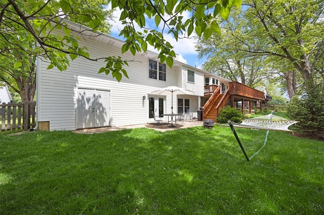 back of property with a deck, stairway, and a patio