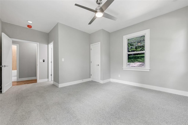 unfurnished bedroom featuring carpet flooring, baseboards, and ceiling fan