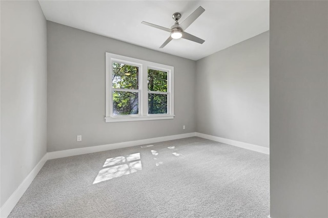 empty room featuring a ceiling fan, carpet floors, and baseboards
