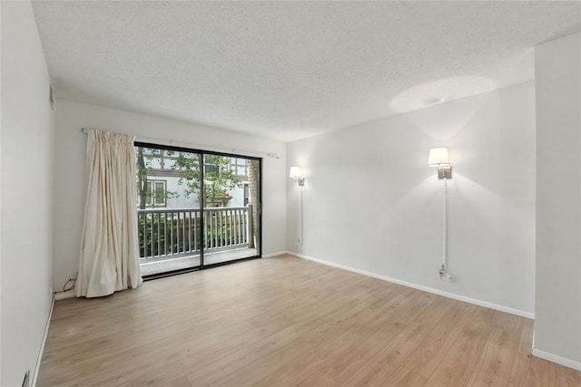 444 N Clay Ave Unit 2N, Kirkwood, MO 63122 - spare room with a textured ceiling, light wood finished floors, and baseboards