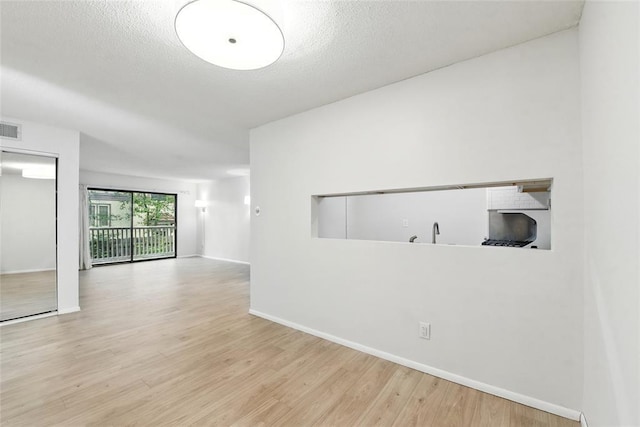 444 N Clay Ave Unit 2N, Kirkwood, MO 63122 - spare room featuring wood finished floors, baseboards, and a textured ceiling
