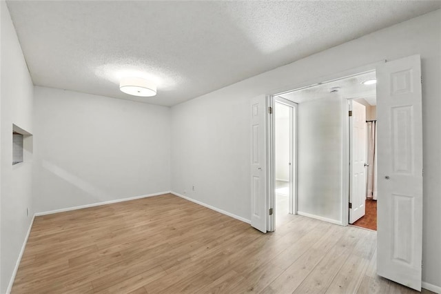 444 N Clay Ave Unit 2N, Kirkwood, MO 63122 - empty room with a textured ceiling, light wood-type flooring, and baseboards