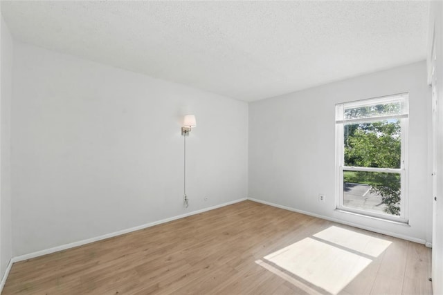 444 N Clay Ave Unit 2N, Kirkwood, MO 63122 - spare room featuring light wood-style floors, a textured ceiling, and baseboards