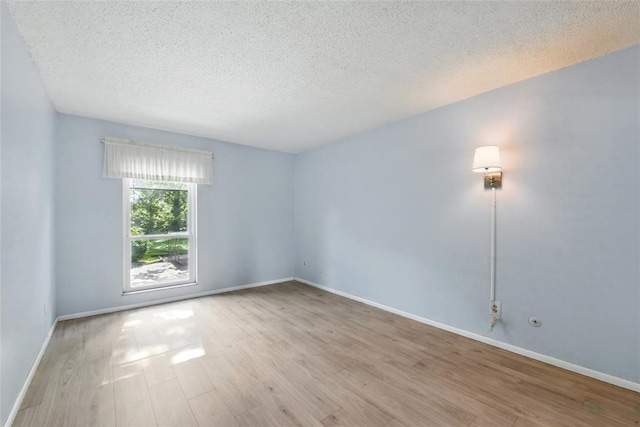 444 N Clay Ave Unit 2N, Kirkwood, MO 63122 - unfurnished room featuring wood finished floors, a textured ceiling, and baseboards