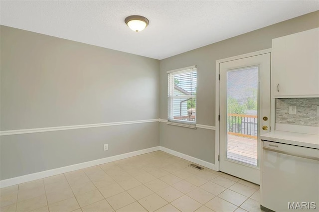 229 Stillbrook Estates Dr, Fenton, MO 63026 - unfurnished dining area featuring a textured ceiling and light tile patterned floors