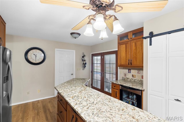 8 Baron Ridge Ct, Ofallon, MO 63366 - kitchen with beverage cooler, stainless steel fridge, brown cabinets, dark wood-style floors, and glass insert cabinets