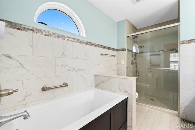 8 Baron Ridge Ct, Ofallon, MO 63366 - bathroom featuring a shower stall, tile walls, and a bath