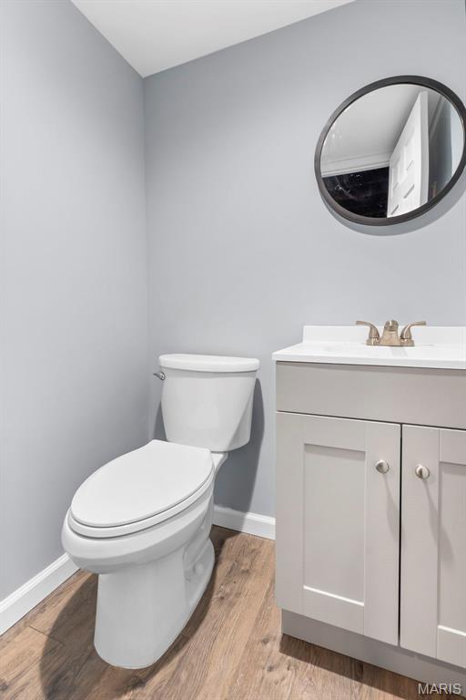 8 Baron Ridge Ct, Ofallon, MO 63366 - half bathroom featuring vanity and wood finished floors