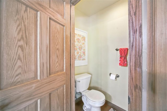 bathroom with toilet and baseboards
