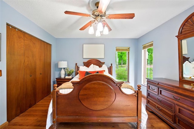 bedroom featuring wood finished floors, a closet, and ceiling fan